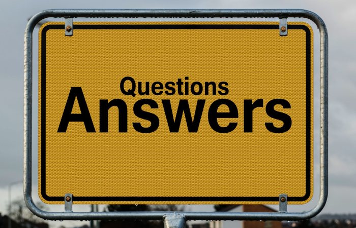 Yellow sign with text questions and answers suggesting direction in decision-making.