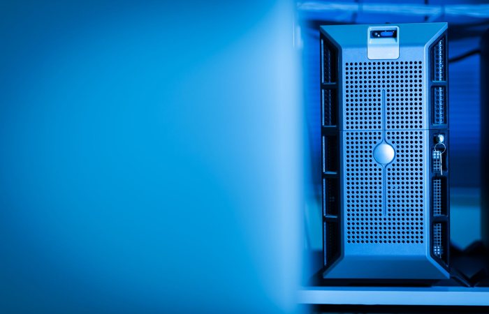 Close-up of a modern server unit in a blue-lit data center environment.