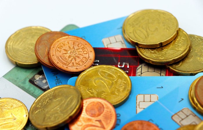 Close-up image of Euro coins and credit cards representing modern financial transactions.