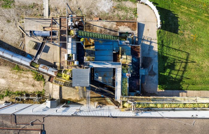 Drone shot of an industrial plant in Plainview, MN showcasing machinery and conveyors.